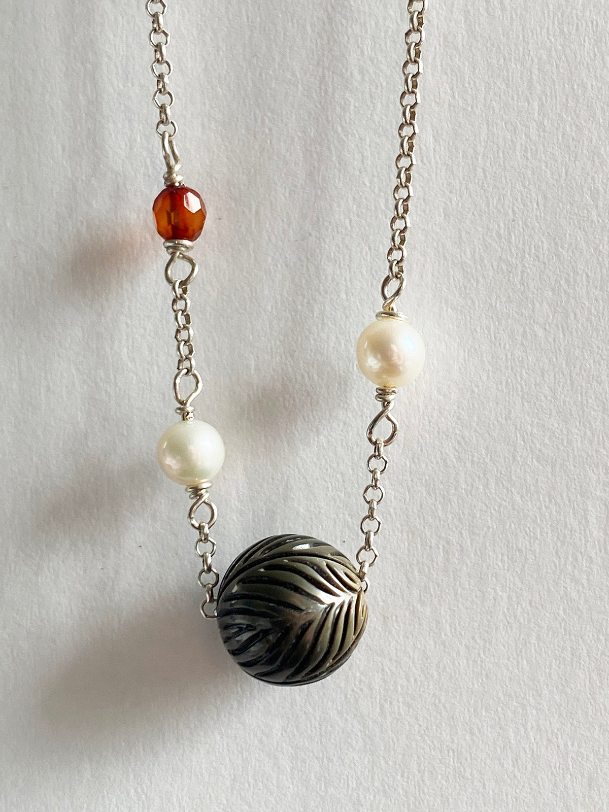 11mm Floating Carved Tahitian Pearl with White Pearls and Garnets by Linda Queally