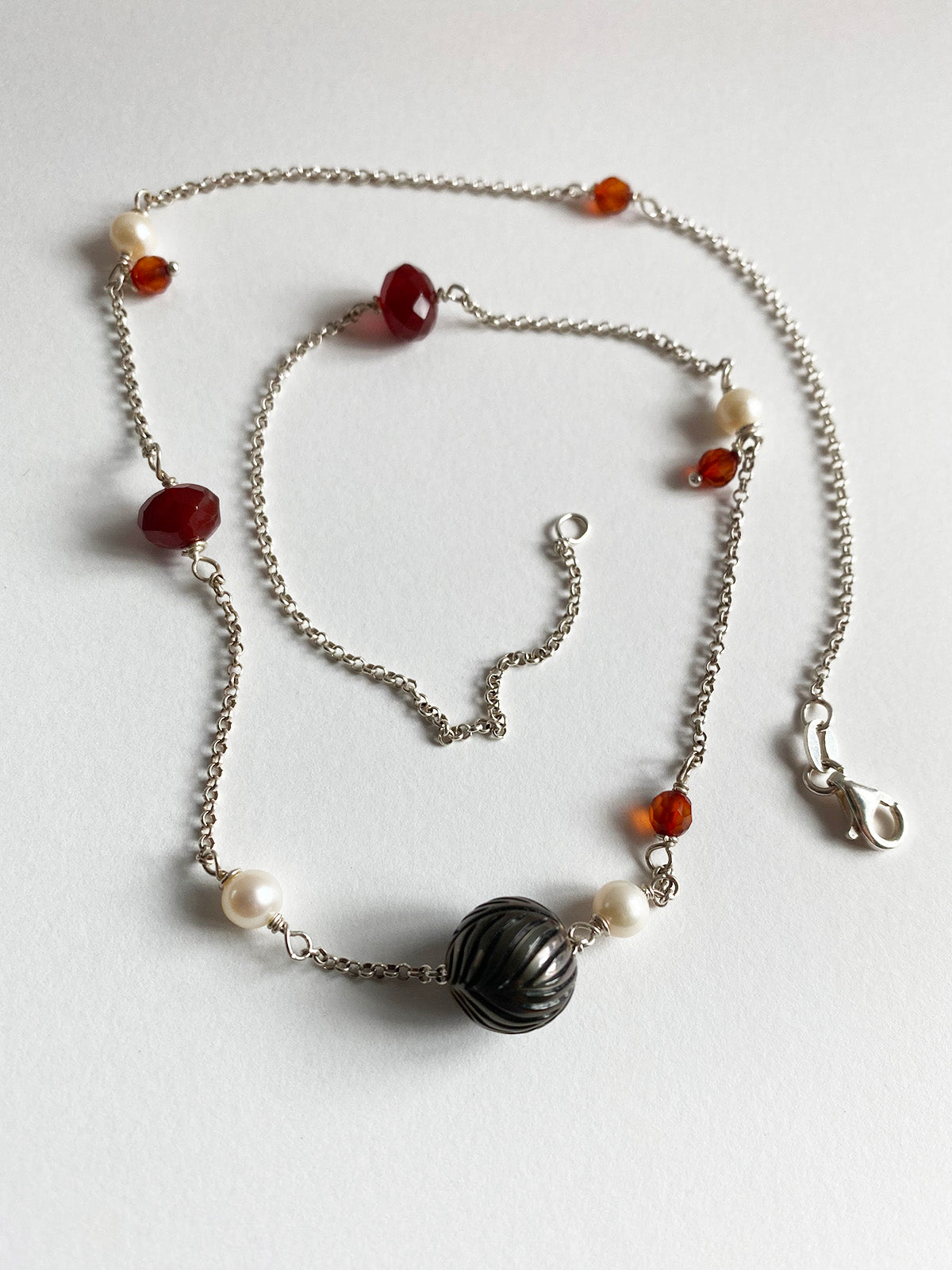 11mm Floating Carved Tahitian Pearl with White Pearls and Garnets by Linda Queally